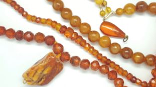 Amber necklace, 11mm reconstituted amber beads, along with two orange bead necklaces and a pendant