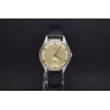 A GENTLEMANS OVERSIZED OMEGA STAINLESS STEEL WRIST WATCH. Circa 1950s. It has a cream coloured