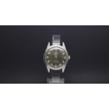 A GENTLEMEN'S W10 MILITARY HMT STAINLESS STEEL WRIST WATCH, black dial with luminous markers and