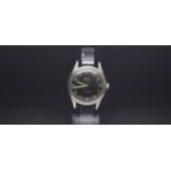 A GENTLEMEN'S W10 MILITARY HMT STAINLESS STEEL WRIST WATCH, black dial with luminous markers and