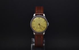 A GENTLEMANS LONGINES STAINLESS STEEL WRIST WATCH. Circa 1940s. The watch has a arabic numerals with