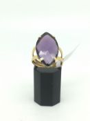 18ct Gold Ring set with a purple stone 3.85g