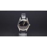 A GENTLEMEN'S W10 MILITARY HMT STAINLESS STEEL WRIST WATCH, black dial with luminous markers and