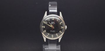 A GENTLEMEN'S W10 MILITARY HMT STAINLESS STEEL WRIST WATCH, black dial with luminous markers and