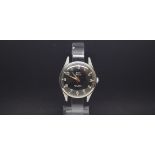 A GENTLEMEN'S W10 MILITARY HMT STAINLESS STEEL WRIST WATCH, black dial with luminous markers and