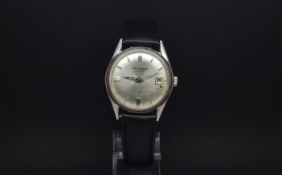 A GENTLEMANS J W BENSON STAINLESS STEEL WRIST WATCH. Circa 1960s The dial is silver in colour with