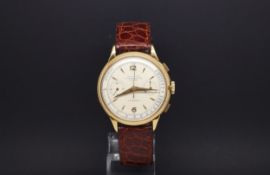 A GENTLEMANS 18ct Gold INVICTA CHRONOGRAPH WRIST WATCH. Circa 1940s. It has two registers on a white
