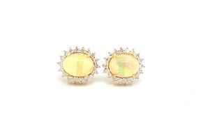 Opal and diamond cluster earrings oval cabochon cut opal weighing an estimated total of 4.40ct