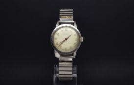 A GENTLEMANS GARRARD STAINLESS STEEL WRIST WATCH. Circa 1960s A off white cream dial with arabic