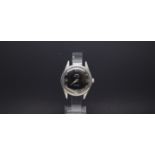 A GENTLEMEN'S W10 MILITARY HMT STAINLESS STEEL WRIST WATCH, black dial with luminous markers and