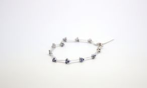 Sapphire and white metal bracelet, each cluster to a knife edge link, stamped '10K', weight 4.5g