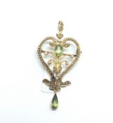 A 15ct gold peridot and seed pearl pendant/brooch. Some pearls deficient. 5.4g