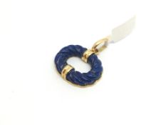 An 18ct gold pendant set with lapis lazuli. Stamped 750. 9.1g