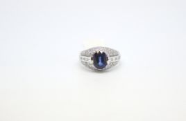 Sapphire and diamond ring, central oval cut sapphire weighing an estimated 3.30ct, with a row of
