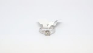 Diamond Solitaire Ring with Baguette cut shoulders. The round cut diamond weighing 1.24cts and the