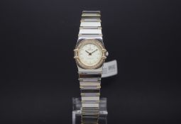 Ladies' Omega Contstellation, white dial with round hour markers, diamond set bezel, steel and