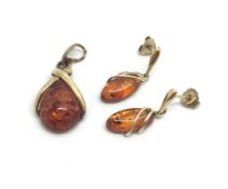 A pair of 9ct gold amber set earrings and a 9ct Amber pendant. 4.1g