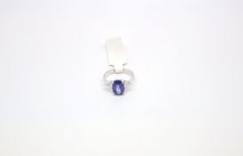 Sapphire and diamond three stone, oval cut sapphire, 10.4x7.1mm, mounted with a single brilliant cut