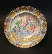 A Canton famille rose dish, circa 1840, painted with figures at leisure on a garden terrace, 25cm