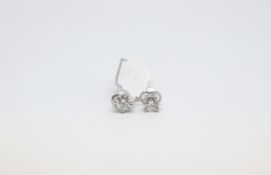 A pair of round cut diamond studs. Total carat weight 1.60cts. 18ct white gold with butterfly