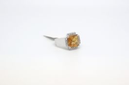 A citrine and diamond ring by Chatila. The square citrine surrounded by diamonds. Signed Chatila and