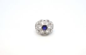 Sapphire and diamond cocktail ring, central round cut sapphire weighing an estimated 0.90ct,