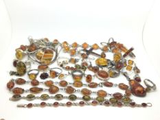 A large quantity of amber set silver jewellery. 287g