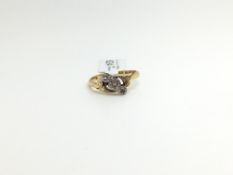 An 18ct Gold and Platinum Three Stone Diamond Ring. Ring Size K