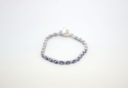 Sapphire and diamond bracelet, oval cut sapphires spaced with pairs of diamonds, (27) estimated