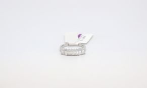 An emerald cut diamond ring. 7 emerald cut diamond rings totalling 1.36cts. Size N 1/2
