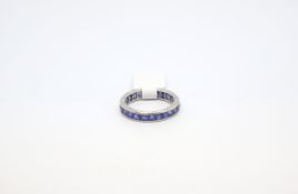 Art Deco sapphire eternity ring, square cut sapphires channel set in carved white metal mount,