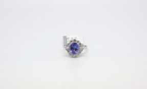 A tanzanite and diamond 18ct gold ring. The tanzanite weighing 2.2cts and surrounded by 0.86cts of