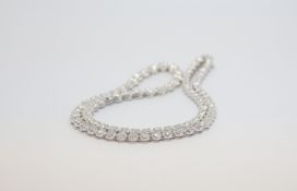 Diamond riviere necklace, graduating brilliant cut diamonds four claw set within illusion mounts,