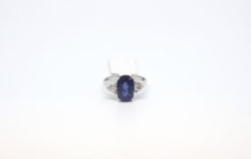 Sapphire and diamond three stone ring, central oval cut sapphire 11.2x7.2mm weighing an estimated