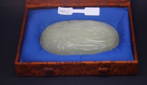 a Circa 18th century jade plaque of oval form carved in low relief with a finger citron growing from