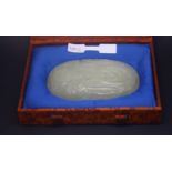 a Circa 18th century jade plaque of oval form carved in low relief with a finger citron growing from