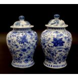A Pair Of Chinese Porcelain Baluster Vases, Each With Cover And Painted Blue And With Bird And