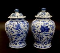 A Pair Of Chinese Porcelain Baluster Vases, Each With Cover And Painted Blue And With Bird And