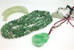 A collection of Jade jewellery. Including a strand of beads, a necklace, bracelet and bangle. Bangle