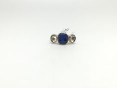 A Three stone sapphire and diamond ring. The central fancy cut sapphire with a rose cut diamond to
