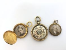 Three Victorian yellow metal mourning lockets, two gilt metal and one testing as 9ct