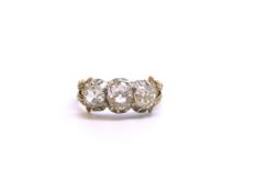 A 19th Century three stone diamond ring engraved October 1831. Open back diamonds. Estimated total