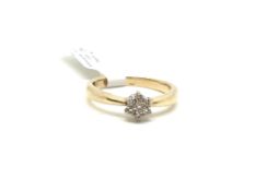 Diamond daisy cluster ring, seven diamonds set in white metal, yellow metal band, stamped and tested