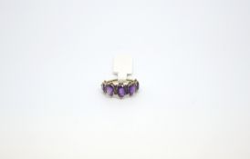Victorian amethyst five stone ring, five graduating amethysts collet set with ball detail across and