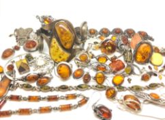 a large selection of Amber jewellery set items including Bangle, pendants, rings eta, marked and