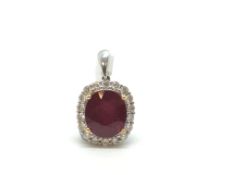 Treated ruby and diamond pendant, oval cut ruby approximately 11.7 x 10.4mm, four claw set with a