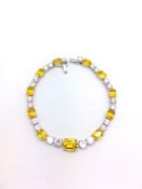 An Impressive Yellow Sapphire and Diamond Bracelet. The estimated 7cts of diamonds and 12cts of