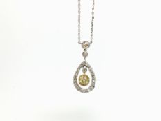 A natural yellow old cut diamond pendant, with diamond halo and an integrated chain. Chain tests