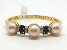 Pearl, diamond and polite bangle, three 13/14mm pinkish button pearls spaced by isolates and