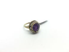 Amethyst and seed pearl continental ring, central fund cut amethyst set with a border of seed